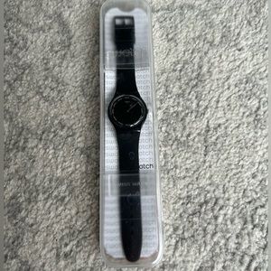 Women’s black Swatch watch